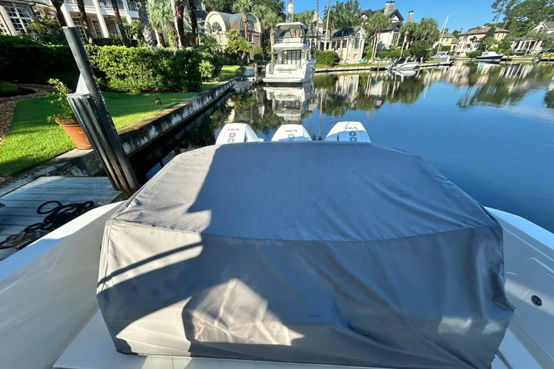 Slide: The Image of 2023 Tiara Yachts 38 LS docked, covered, with scenic waterfront view. - 11