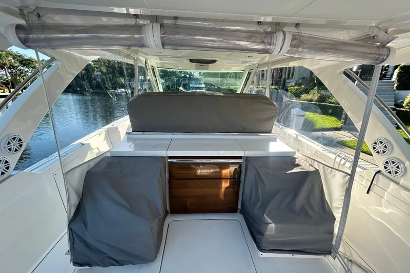 Slide: The Image of 2023 Tiara Yachts 38 LS interior with covered seating and sleek design. - 14