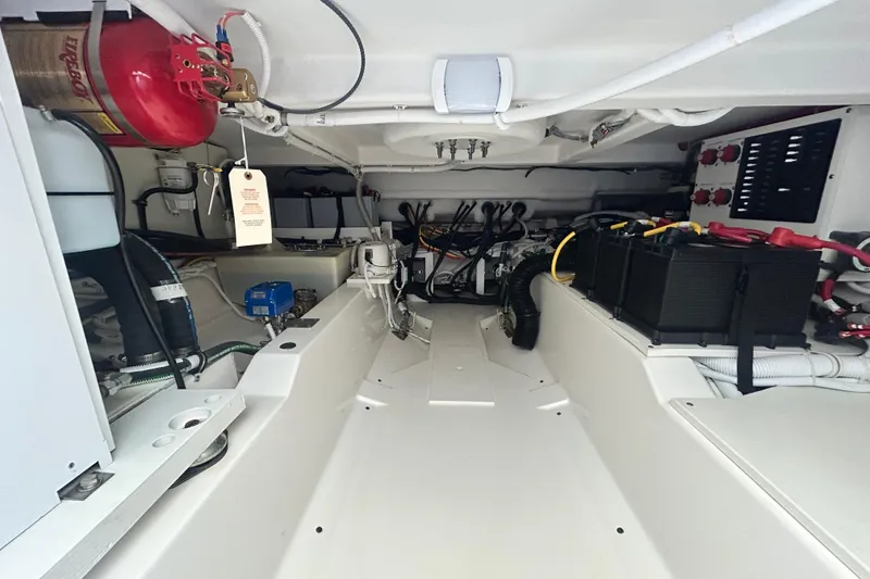Slide: The Image of Engine compartment of 2023 Tiara Yachts 38 LS, showcasing wiring and equipment. - 17