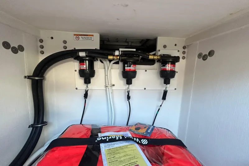 Slide: The Image of Engine compartment of 2023 Tiara Yachts 38 LS with fuel filters and safety equipment. - 20