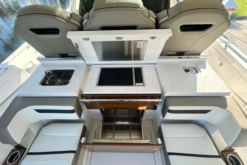 Slide: The Image of 2023 Tiara Yachts 38 LS boat interior with sink, grill, and seating area. - 22