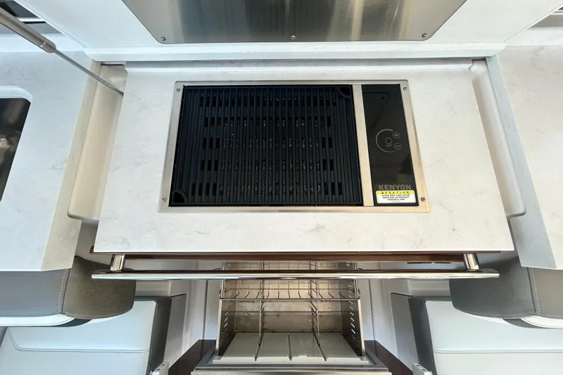 Slide: The Image of 2023 Tiara Yachts 38 LS kitchen with Kenyon grill and modern design. - 23