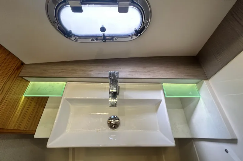 Slide: The Image of Modern bathroom sink in 2023 Tiara Yachts 38 LS, featuring sleek design and porthole window. - 34