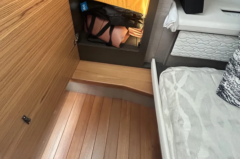 Slide: The Image of 2023 Tiara Yachts 38 LS interior with wooden flooring and storage compartment. - 38
