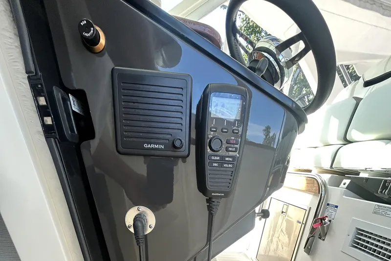 Slide: The Image of 2023 Tiara Yachts 38 LS helm with Garmin controls and steering wheel. - 39