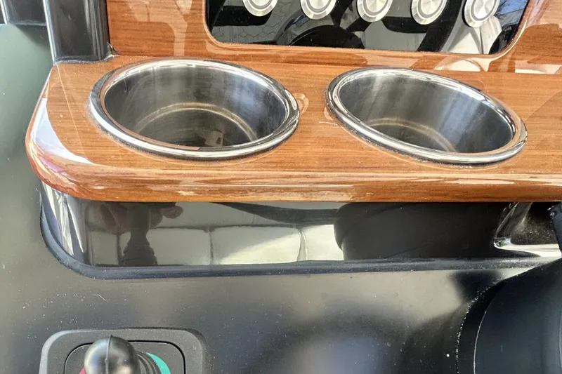 Slide: The Image of 2023 Tiara Yachts 38 LS dashboard with dual cup holders and control panel. - 40