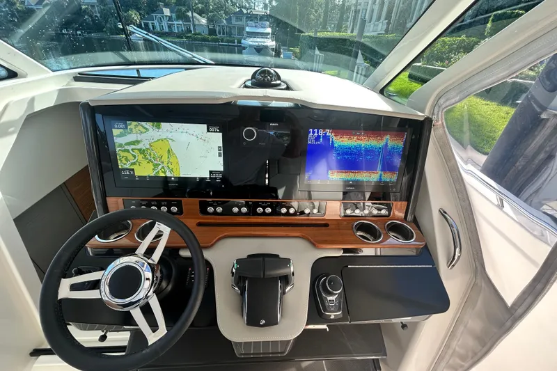 Slide: The Image of Helm of 2023 Tiara Yachts 38 LS with advanced navigation displays and controls. - 41