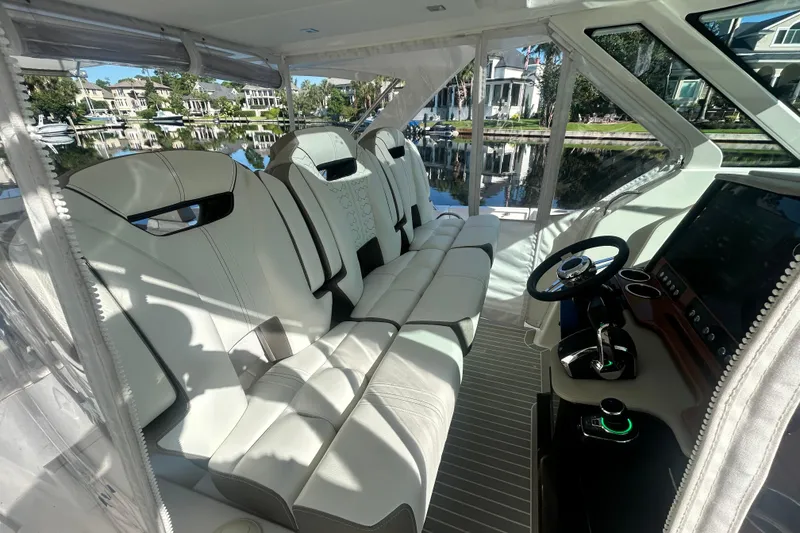 Slide: The Image of 2023 Tiara Yachts 38 LS interior with luxurious seating and modern helm controls. - 45