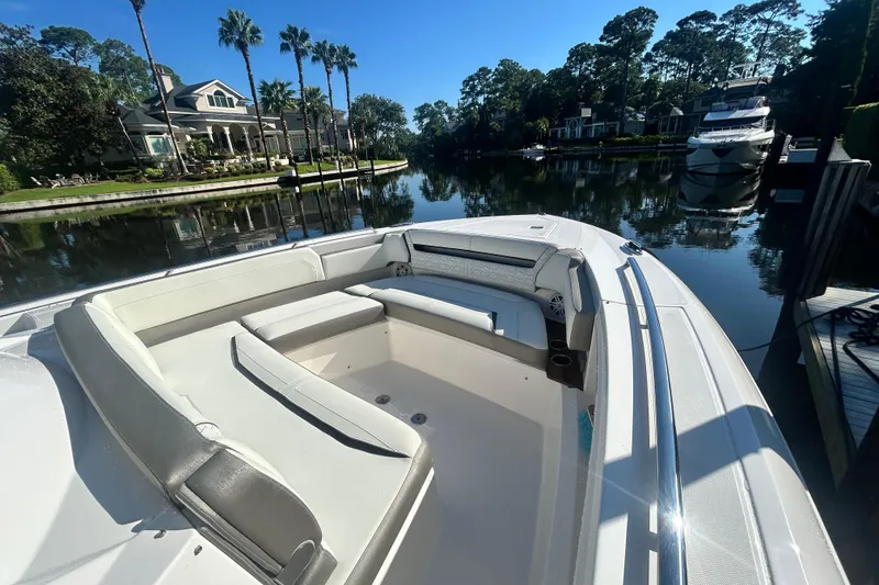 Slide: The Image of 2023 Tiara Yachts 38 LS boat docked in a scenic waterfront setting. - 46