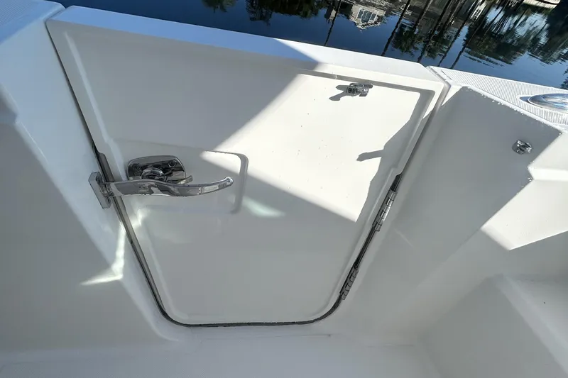 Slide: The Image of 2023 Tiara Yachts 38 LS boat door with chrome handle, dockside view. - 48