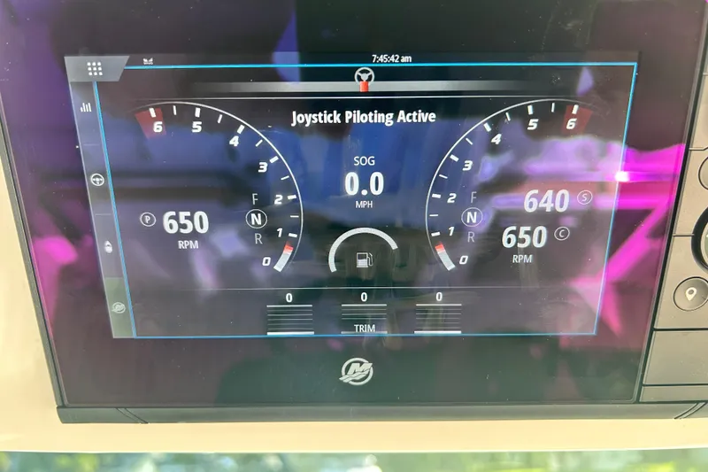 Slide: The Image of Dashboard of 2023 Tiara Yachts 38 LS showing joystick piloting and RPM gauges. - 54