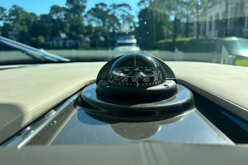 Slide: The Image of Compass on 2023 Tiara Yachts 38 LS dashboard, surrounded by scenic view. - 55