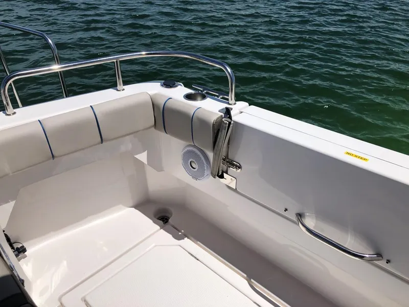 Slide: The Image of 2025 Cutwater C-32 Sedan boat interior with cushioned seating and railing, overlooking water. - 10