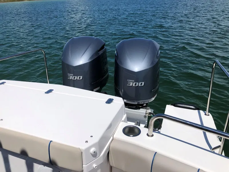 Slide: The Image of 2025 Cutwater C-32 Sedan with twin Yamaha 300 outboard engines on a calm lake. - 11