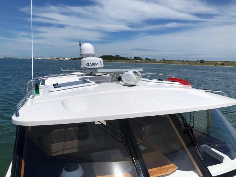 Slide: The Image of 2025 Cutwater C-32 Sedan boat with Garmin equipment on a sunny day. - 13