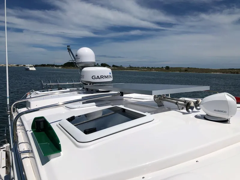 Slide: The Image of 2025 Cutwater C-32 Sedan boat with Garmin navigation on a sunny day. - 18