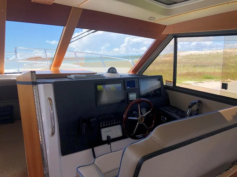 Slide: The Image of Interior of 2025 Cutwater C-32 Sedan boat with modern navigation controls. - 19