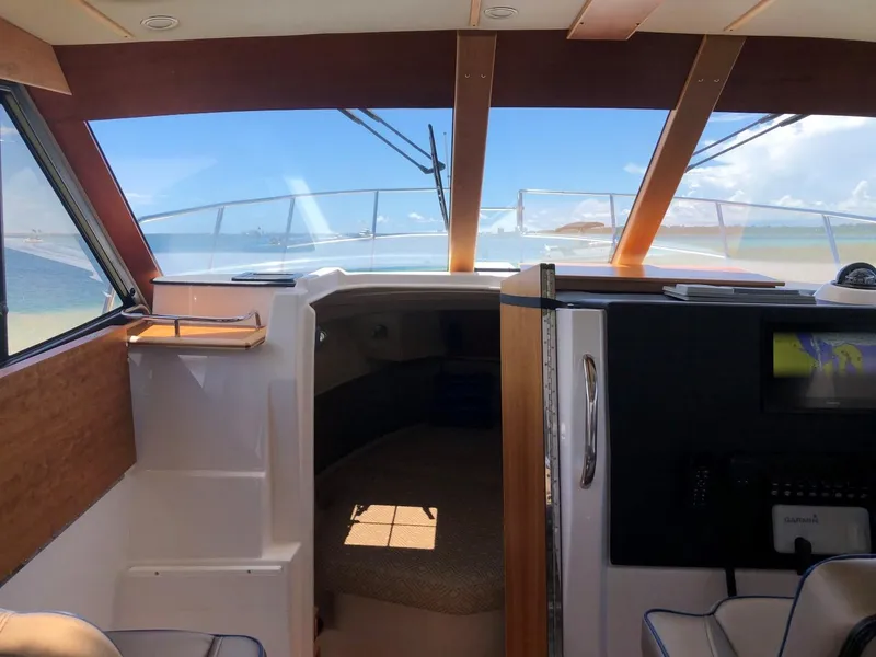 Slide: The Image of Interior view of 2025 Cutwater C-32 Sedan boat with ocean backdrop. - 20