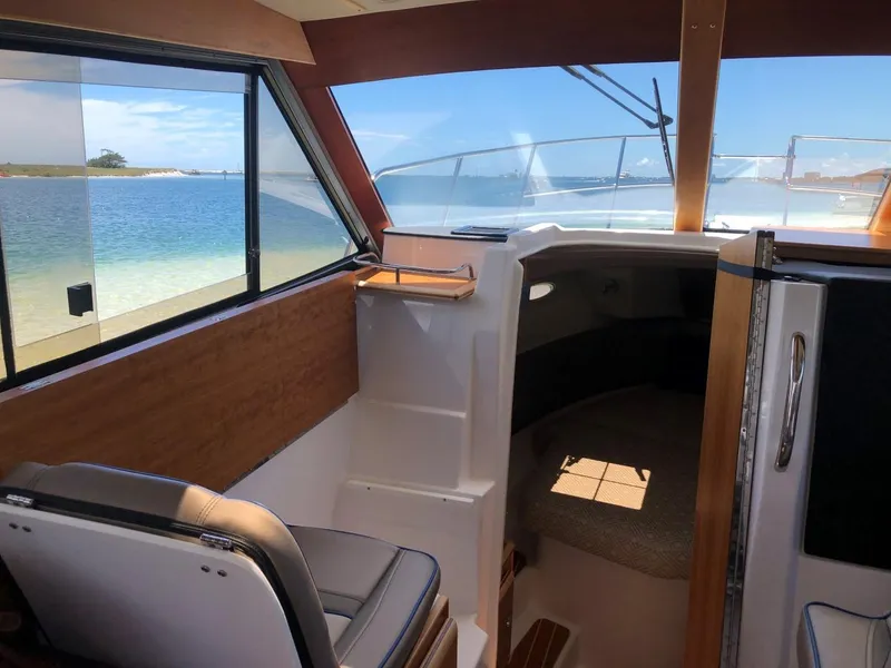 Slide: The Image of Interior view of 2025 Cutwater C-32 Sedan boat with ocean backdrop. - 21