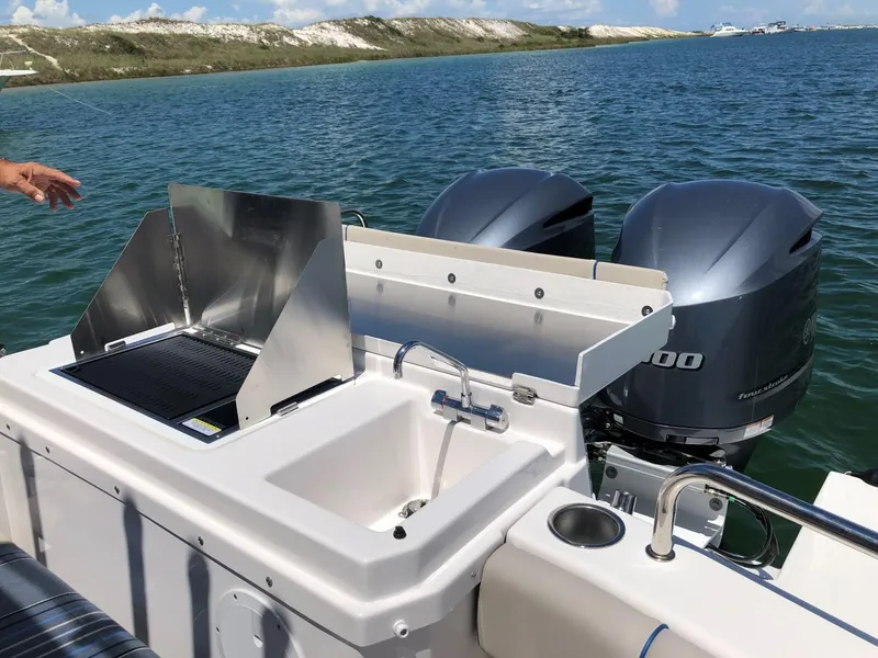 Slide: The Image of 2025 Cutwater C-32 Sedan boat with outdoor sink and grill, dual engines, on a sunny day. - 7
