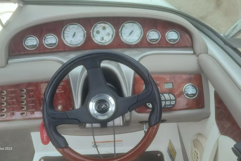 Slide: The Image of Dashboard of a 2006 Cobalt 240 boat with gauges and steering wheel. - 10