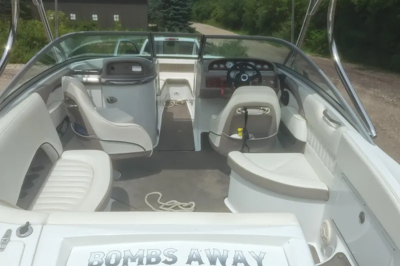 Slide: The Image of 2006 Cobalt 240 boat interior with white seating and dashboard, labeled "Bombs Away." - 11