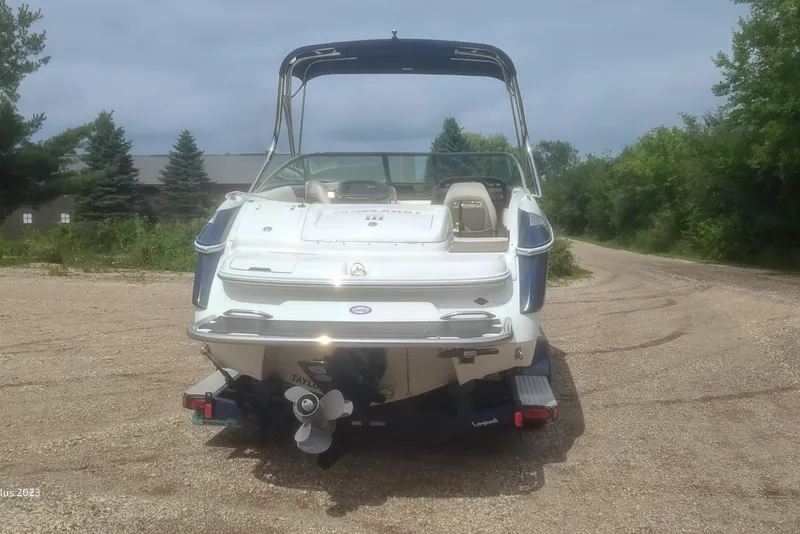 Slide: The Image of 2006 Cobalt 240 boat on a gravel path, surrounded by greenery. - 6