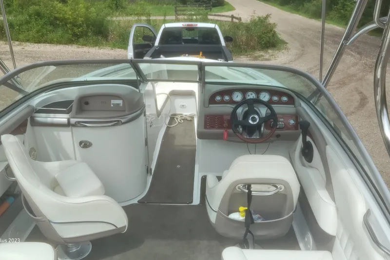 Slide: The Image of Interior of a 2006 Cobalt 240 boat with steering wheel and seating. - 8