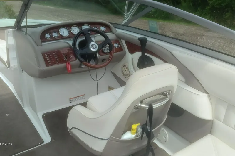 Slide: The Image of Interior of a 2006 Cobalt 240 boat featuring steering wheel and dashboard controls. - 9