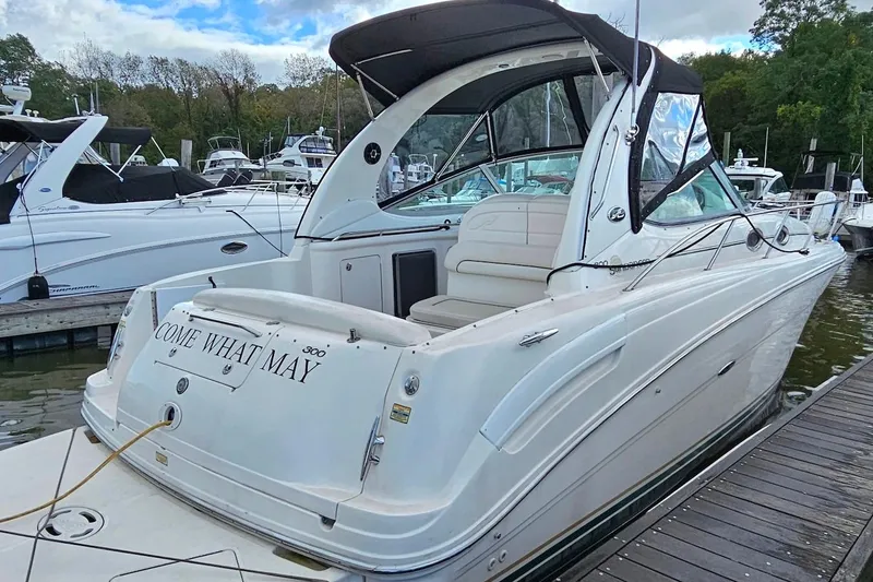 Slide: The Image of 2002 Sea Ray 300 Sundancer docked, featuring sleek design and spacious seating. - 1