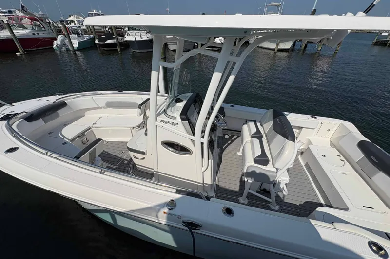 Slide: The Image of 2019 Robalo R242 Explorer boat docked, featuring spacious seating and modern design. - 11