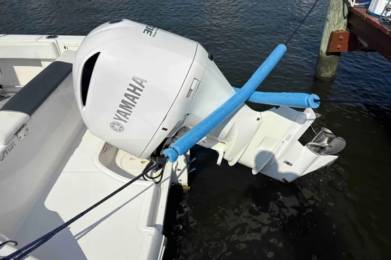 Slide: The Image of 2019 Robalo R242 Explorer with Yamaha outboard motor, docked on water. - 14