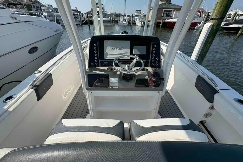 Slide: The Image of 2019 Robalo R242 Explorer boat cockpit with Garmin navigation system at marina. - 4