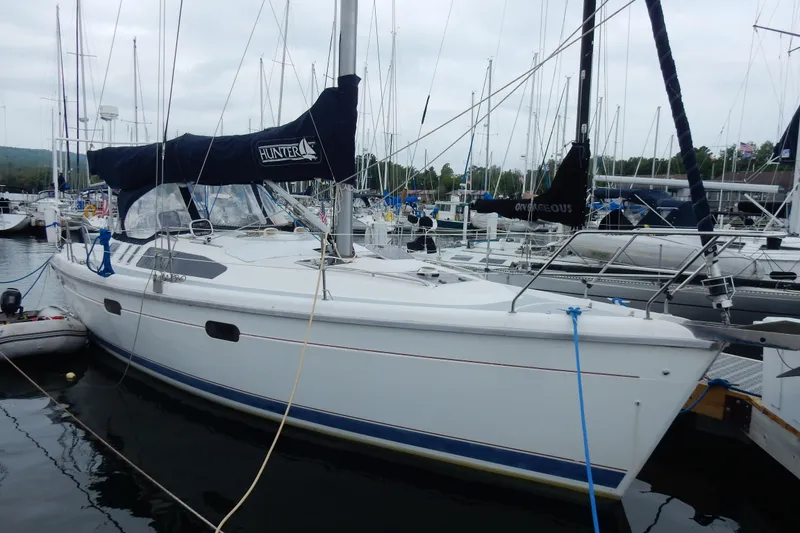 The Image of 1996 Hunter 376 sailboat docked at marina, featuring sleek design and blue accents. - 0