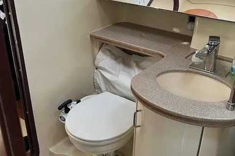 Slide: The Image of Compact bathroom in a 1996 Hunter 376 sailboat with sink and toilet. - 14