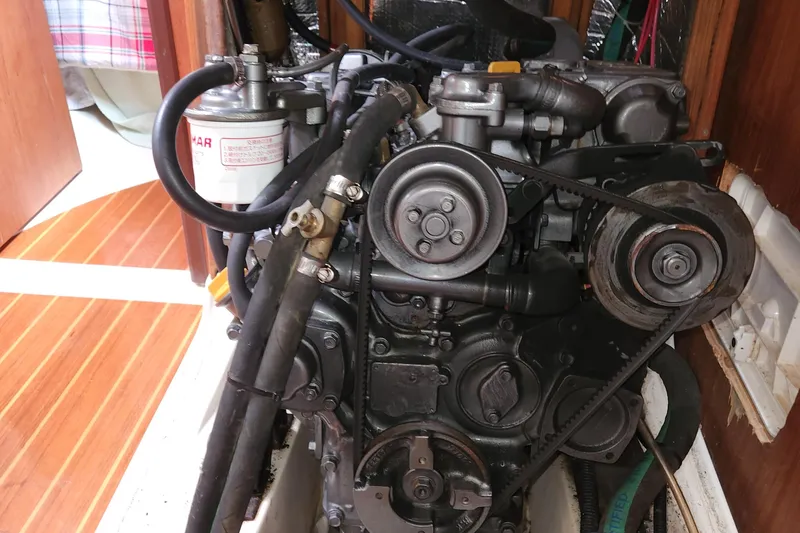 Slide: The Image of Engine of a 1996 Hunter 376 sailboat, showcasing belts and components. - 17