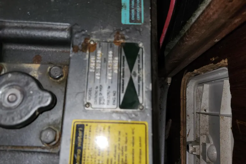 Slide: The Image of Close-up of a 1996 Hunter 376 engine plate with visible labels and rust. - 18