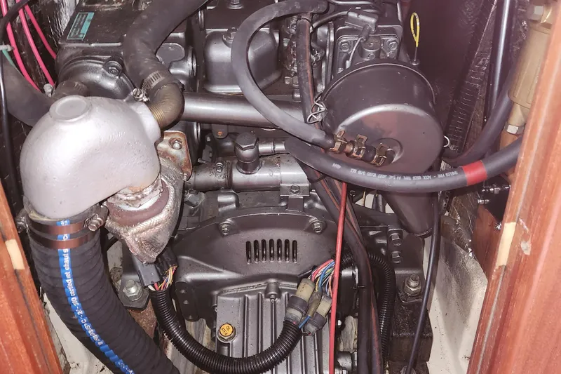 Slide: The Image of Engine compartment of a 1996 Hunter 376 sailboat, showcasing mechanical components and wiring. - 19