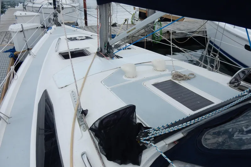 Slide: The Image of 1996 Hunter 376 sailboat docked, showcasing deck and rigging details. - 25
