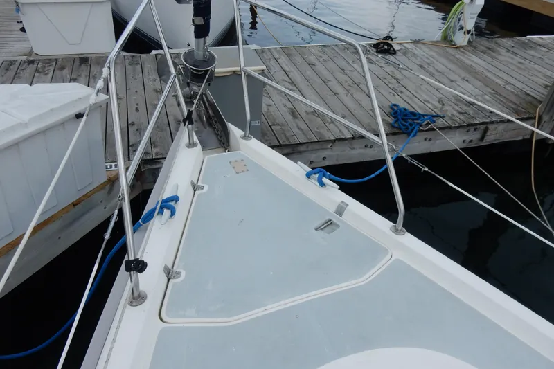 Slide: The Image of Bow of a 1996 Hunter 376 sailboat docked, featuring deck and mooring lines. - 26