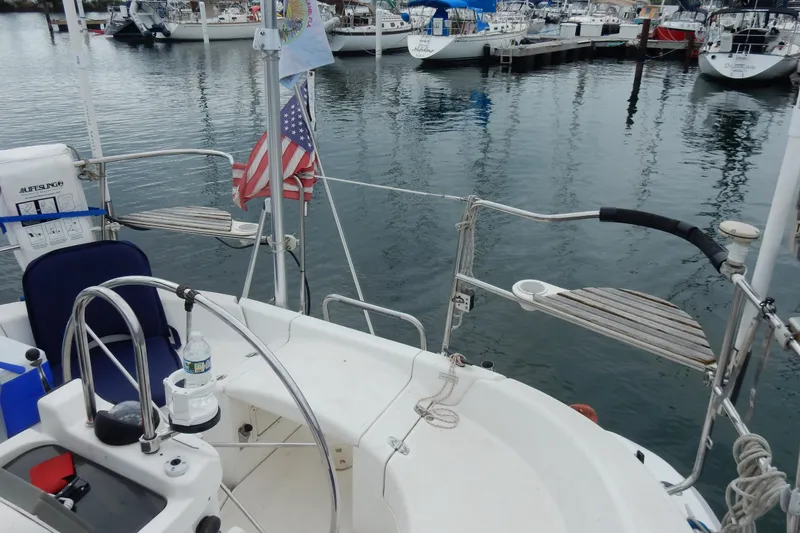 Slide: The Image of Cockpit view of a 1996 Hunter 376 sailboat docked in a marina. - 32