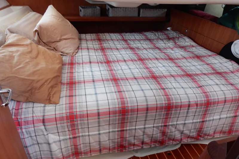 Slide: The Image of Cozy cabin bed with plaid bedding in 1996 Hunter 376 sailboat interior. - 34