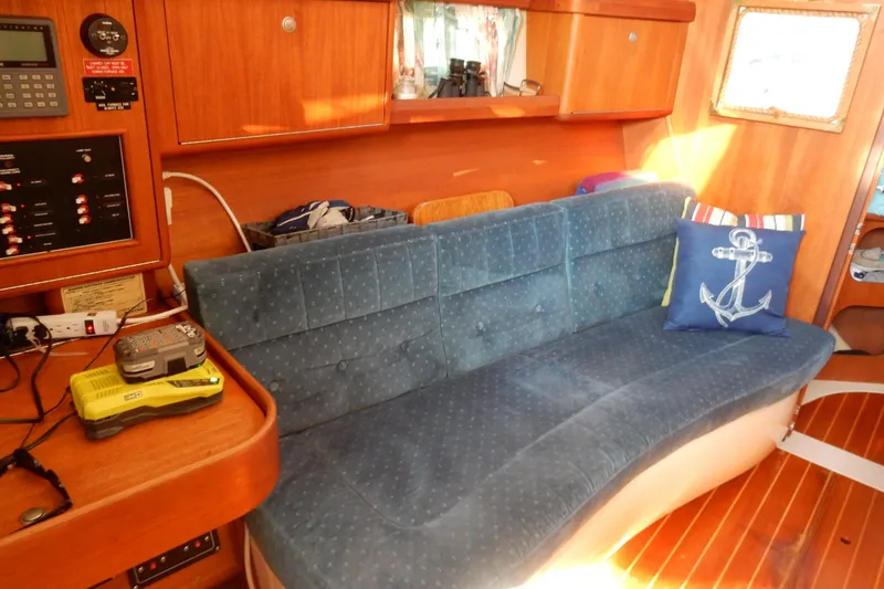 Slide: The Image of Interior of a 1996 Hunter 376 sailboat with blue sofa and nautical decor. - 36