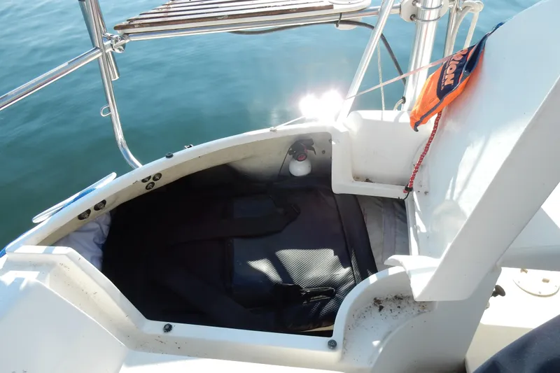 Slide: The Image of Open storage compartment on 1996 Hunter 376 sailboat, with safety equipment and sunlight reflection. - 37