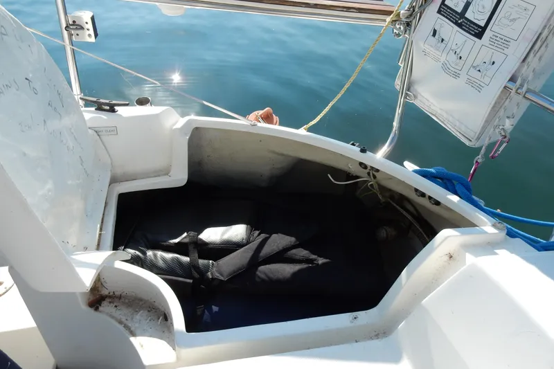 Slide: The Image of Open storage compartment on a 1996 Hunter 376 sailboat, with ropes and safety instructions visible. - 38