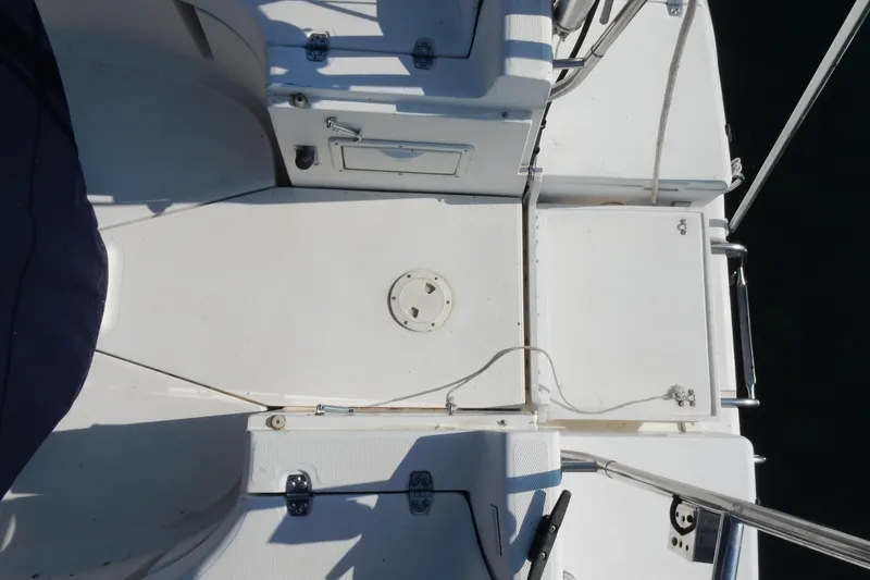 Slide: The Image of Deck view of a 1996 Hunter 376 sailboat, featuring storage compartments and railing. - 43