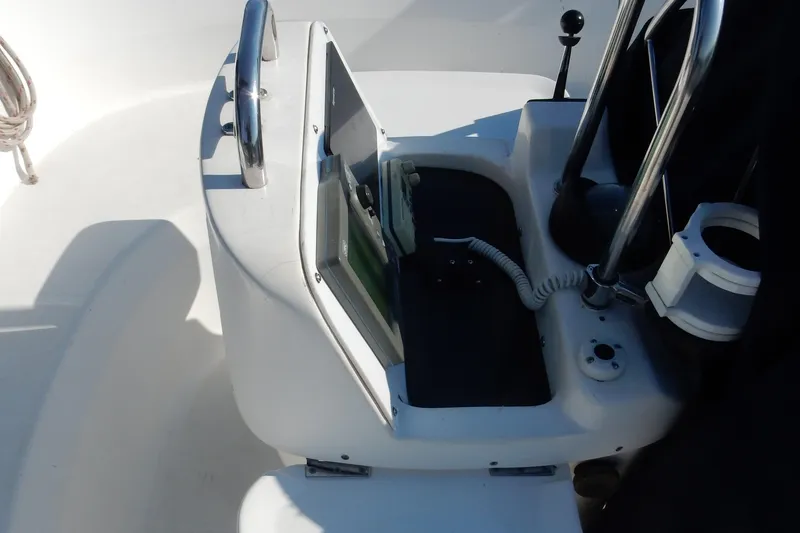 Slide: The Image of Cockpit of 1996 Hunter 376 sailboat with steering wheel and navigation equipment. - 44