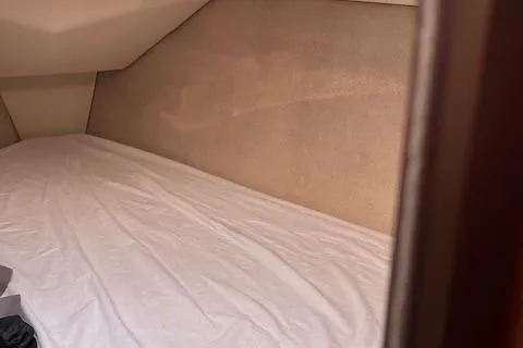 Slide: The Image of Interior cabin of a 1996 Hunter 376 sailboat with a neatly made bed. - 9