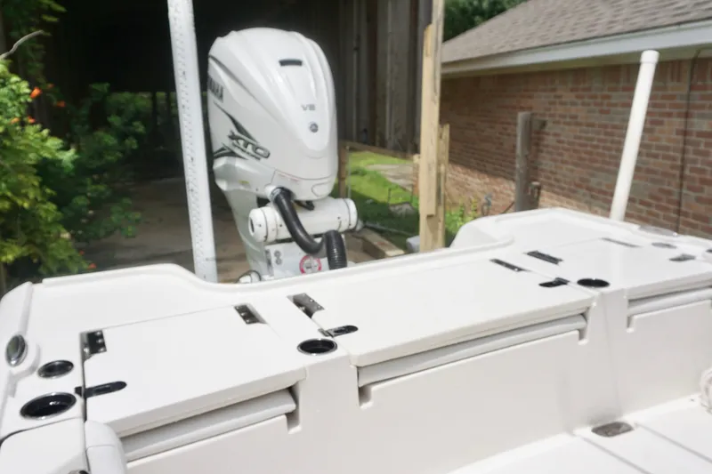 Slide: The Image of 2019 Tidewater 2700 Carolina Bay boat with Yamaha V8 engine in a driveway. - 14
