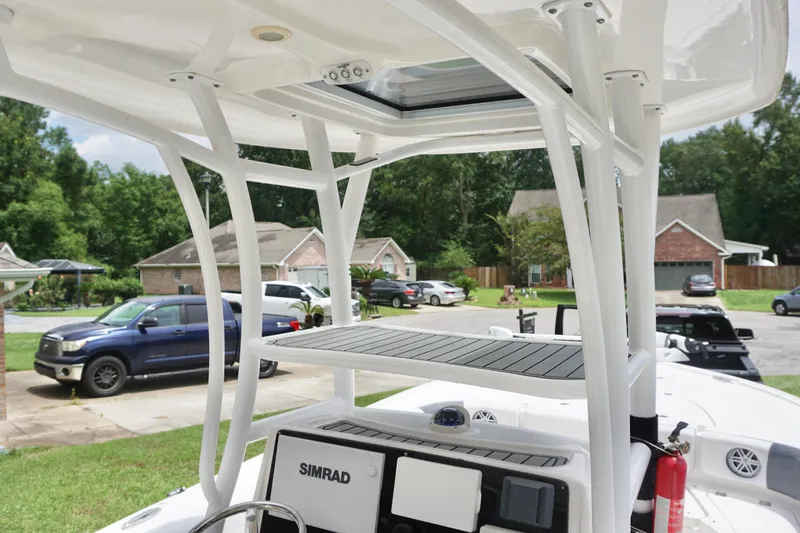 Slide: The Image of 2019 Tidewater 2700 Carolina Bay boat with Simrad electronics, parked in a residential area. - 17